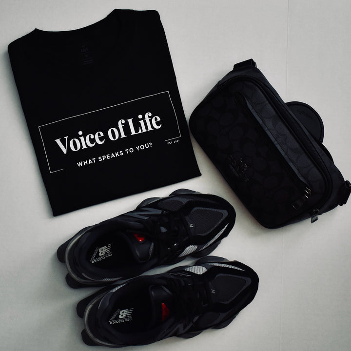 Signature tee in black with new balance shoes and coach crossbody