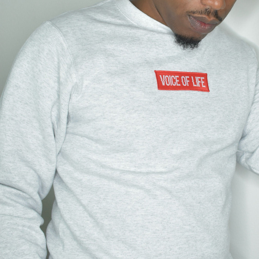 Ash color sweatshirt with red voice of life patch