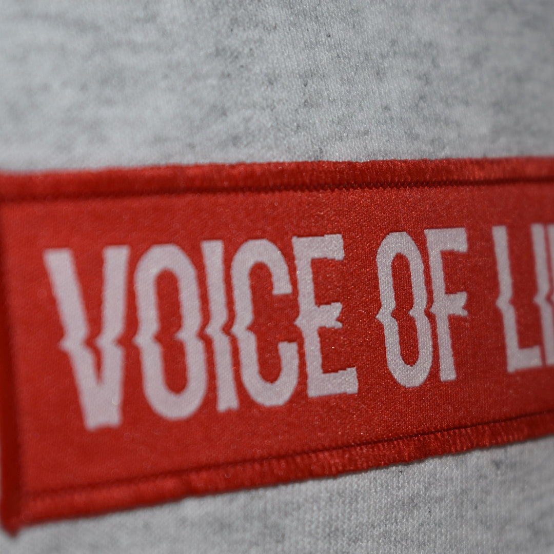 Zoom in and angled red Voice of Life patch